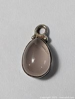 Close-up front view of the teardrop clear/smokey quartz pendant in .925 sterling silver showing the stone and bail attachment.