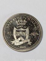 Front view of a $2 Bank of Ontario Bancroft dollar coin dated 2000 showing the town crest with crown, floral design on shield, and banner with 'BANCROFT' inscription.