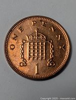 Obverse side of the 2000 British small penny coin showing the denomination 'ONE PENNY' and crowned portcullis emblem.