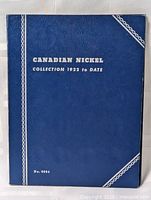 Blue faux-leather coin album cover with gold text 'CANADIAN NICKEL COLLECTION 1922 to DATE' and number 9064 at bottom.