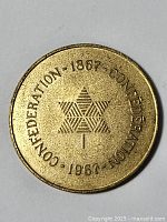 Obverse side of the 1967 Canadian Centennial token with star design and confederation dates