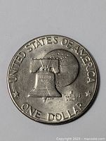 Reverse side showing Liberty Bell and moon design with text 'UNITED STATES OF AMERICA,' 'ONE DOLLAR,' and 'E PLURIBUS UNUM.'