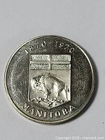 Clear image of the front side of the large Manitoba token showing embossed buffalo and Manitoba shield design, with date 1870-1970 and text Manitoba.