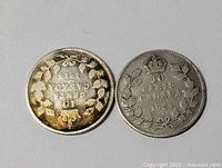 Two Canadian silver dimes showing the reverse side of 1916 and 1931 dated coins with crown and wreath design.