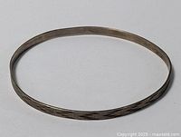 Image showing the full sterling silver cuff bracelet laid flat, displaying the etched geometric pattern around the band.