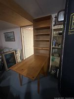 Overall view of the two-piece wooden cabinet with fold-out table extended