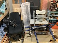 Full view of the manual wheelchair with black seat, footrests, and adjacent bed rail.
