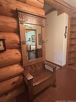 Full view of oak deacon’s bench with mirror and hooks.