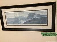 Full view of the framed Robert Bateman print showing landscape scene and frame with dimensions noted on tag.