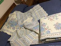 Overview of quilt and two pillow shams showing patterns and condition.