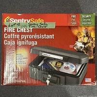 Box showing SentrySafe branding, fireproof and security labels, and image of fire chest with media inside.