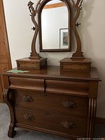 Full view of antique wooden dresser with two drawers and mirror on top