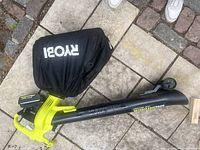 Overhead view of Ryobi leaf mulcher, 4Ah battery attached, and collection bag