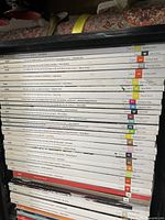 Stack of Dwell Magazine issues in milk crate showing volume, issue number, and quote text on spine for identification.