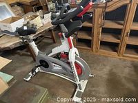 Full side view of Schwinn stationary exercise bike showing frame, seat, and flywheel area.