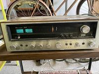 Front view of the Sansui 5050 stereo receiver showing the full front panel with knobs, switches, meters, and wood casing.