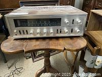 Front angled view of the Sansui stereo amplifier receiver showing the full front panel with knobs and switches.