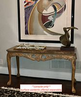 Full front view of console table showing carved base and marble top