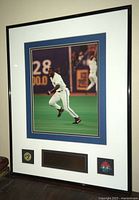 Framed photo showing Joe Carter running on field with autograph and Blue Jays logos