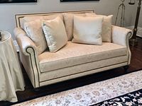 Front view of full love seat with pillows