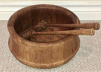 Salad bowl with servers arranged inside showing the bowl's shape and wood grain