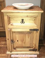 Front view of pine wood end table showing drawer closed and cabinet door closed. Top has a plate on it, sold separately.