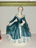View of the Royal Doulton "Janine" figurine facing forward, showing the full dress and figure details.