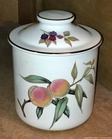 Side view showing peaches and blackberries on the canister