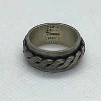 Photo of sterling silver ring showing twisted rope design and dark patina.
