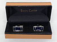 Cuff links displayed inside original Simon Carter box with visible brand name on the interior lid.