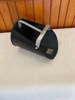 side view showing angled opening and carry bar