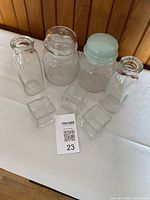 All seven glass items grouped on table
