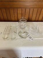 All six clear glass items displayed on table