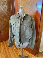 Full front view of the Canadian Army wool battledress jacket on mannequin