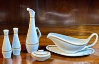 Set of fine bone china pieces: two pepper shakers, oil cruet, mustard pot with lid, gravy boat with under plate, all in Copeland Spode 'Elizabethan' pattern with gold detailing.