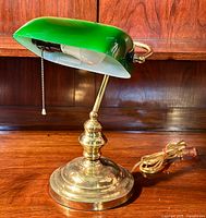 Full view of vintage banker’s lamp showing green glass shade, brass base, and pull chain