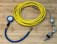 Coiled yellow air hose with pressure gauge and attached air blow gun with filter whole lot overview