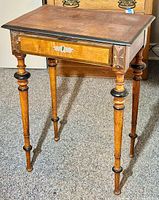Front view showing full table including marquetry inlaid top, drawer front, and turned legs