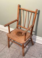 Photo of the vintage child's wooden chair in natural light showing overall design and condition.