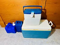 Four coolers arranged on floor showing size and color differences