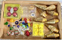 Top view of full tray showing boxed red baubles, gold cone ornaments, yellow chicks, and multiple glass candy decorations.