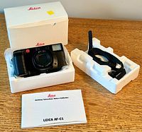 Camera, strap and manual arranged in styrofoam tray inside original Leica box