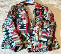 Columbia patterned fleece jacket with tribal geometric design, front zipper visible.