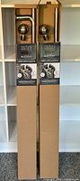 Two boxed Thermaplus Couture blackout curtain rods with visible branding and packaging features.