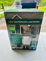 Box front showing Innova LED Outdoor Lantern with energy saving technology and 500 lumens brightness.