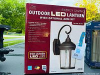 Box showing Altair Outdoor LED Lantern with optional arm kit, 950 lumen LED light source, energy saving model.