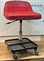 Full view of Black Jack pneumatic shop seat with red padded seat and tool storage base on casters