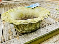 Top angle showing interior and rope design on rim with visible green patina buildup