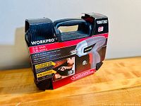 Front view of Workpro cordless screwdriver box showing branding, voltage, lithium-ion battery, and LED illumination information.