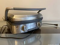 Photo of the Calphalon electric grill showing handle and front control dials with power cord